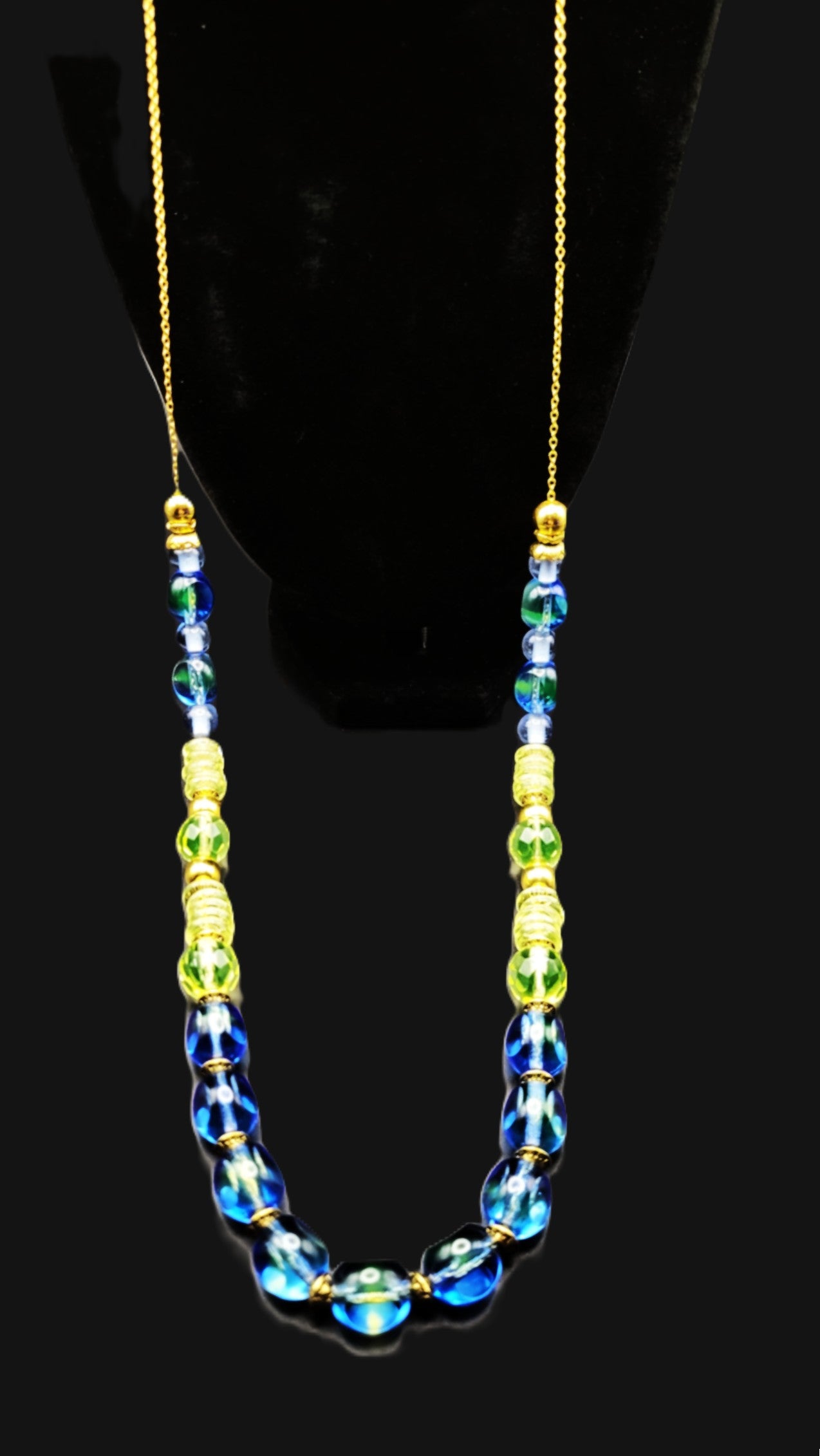 UV Reactive blue and green Czech glass beads strung on a 30" gold tone chain with clasp necklace