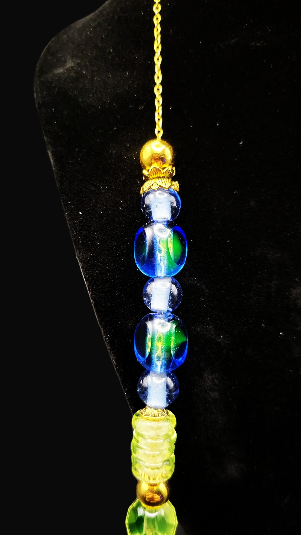 UV Reactive blue and green Czech glass beads strung on a 30" gold tone chain with clasp necklace